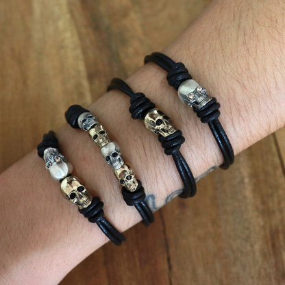Pulsera Plata Macramé Dos Calaveras Bronce
